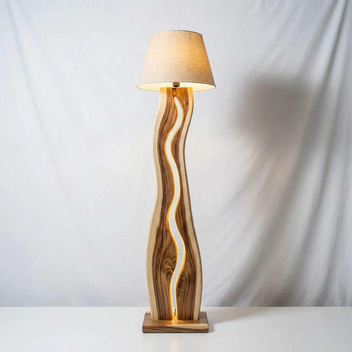Modern wavy wood floor lamp with LED strip and beige lampshade on white background
