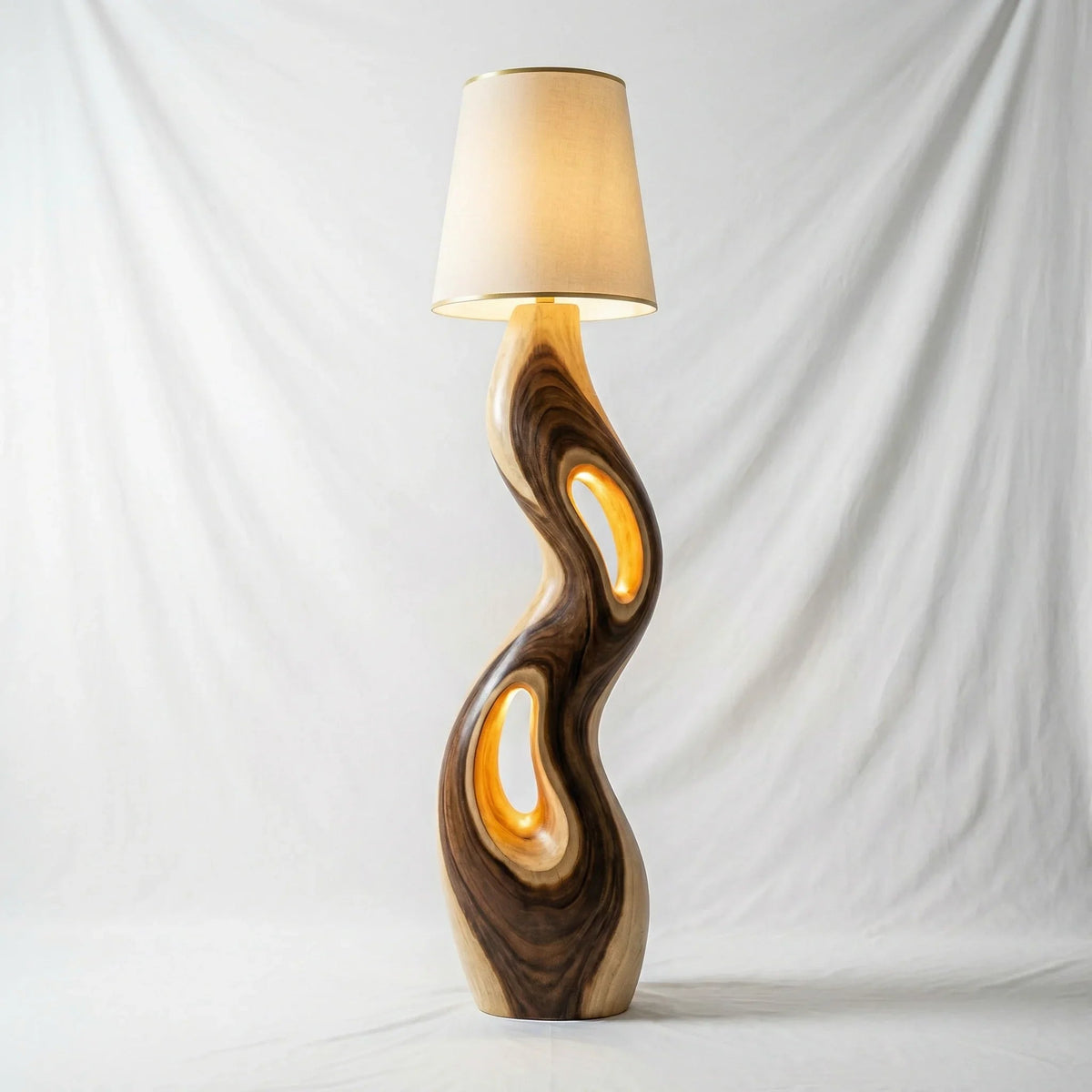 Freeform sculpted wood floor lamp with triple openings and cream lampshade, modern design